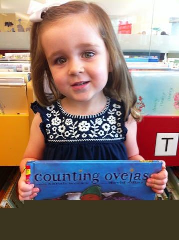 Athena Gamoneda holds Counting Ovejas, a Spanish-language book by Sarah Weeks, at Alvin Sherman Library’s Little Minnows Storytime Fort Lauderdale, Florida. The program, for ages 18-38 months, featured Spanish songs and readings by youth services librarian Meagan Albright.