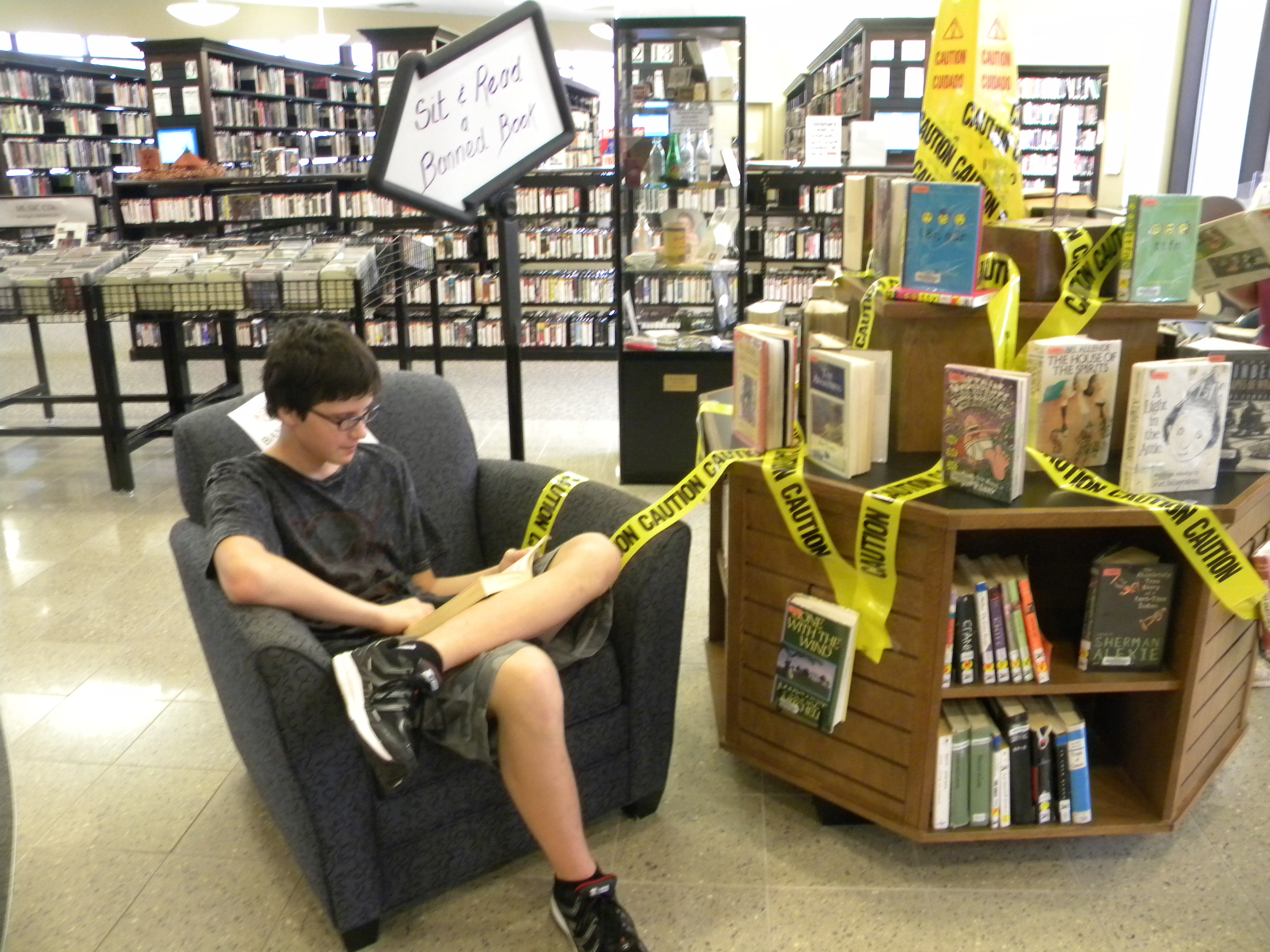 Teen Advisory Group member Danijel Divkovic reads a banned book in the display area at Guthrie Memorial Library in Hanover, Pennsylvania.