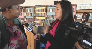 Sharon Anderson, manager of Queens Library's Far Rockaway branch, talks with NY1-TV reporter Suemyra Shah.
