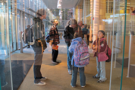 Visitors experience the reinvented Cambridge (Mass.) Public Library at its October 2009 reopening, and are reflected in the moment. Photo: Edward Lifson