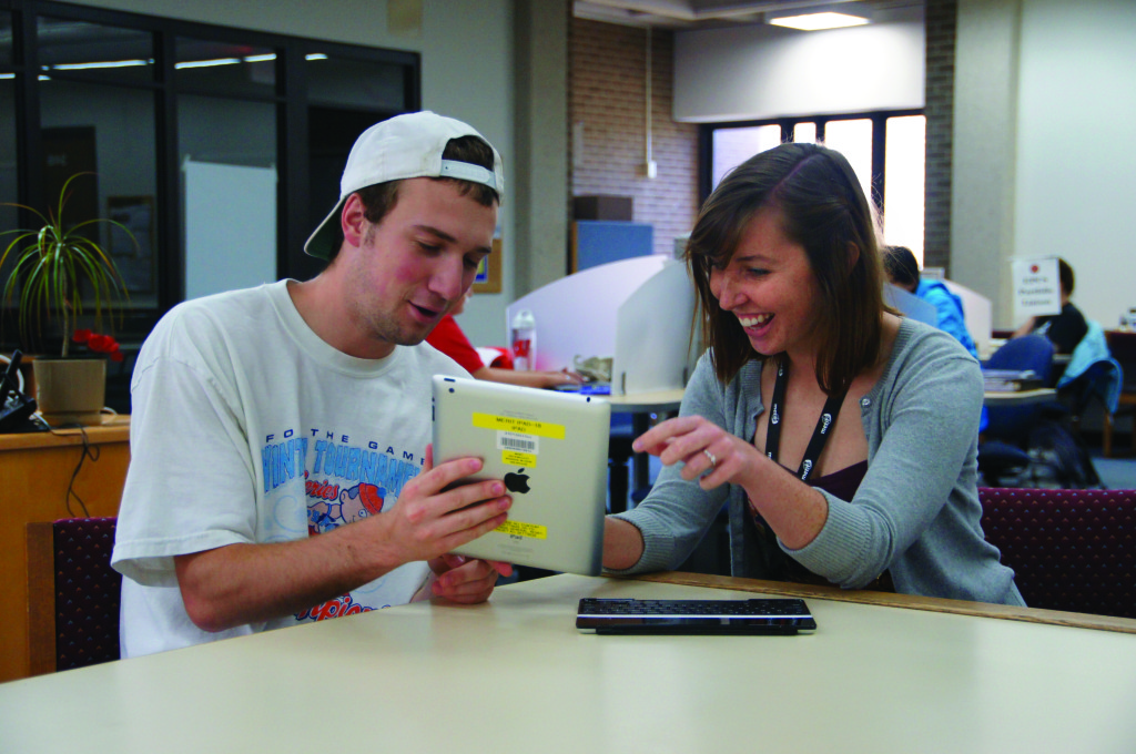 Mary Vogt, MLIS student at University of Wisconsin–Madison (UW), with undergraduate Beau Blakeley. Vogt works as a graduate student assistant at the Media, Education Resources, and Information Technology Library in the School of Education.