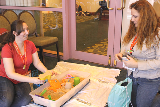 Shaye Caban (left) and Cylinda Richardson-Martin of the Pioneer Library System in Norman, Oklahoma, dig into the program “Libraries: The Ultimate Playground.”