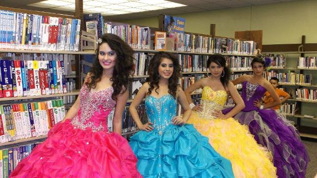 Models from Loara High School in Anaheim, California, pose in dresses for the Quincea era Fashion Show on September 27, the first ever at the city’s Euclid branch.