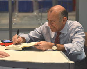 AASL keynote speaker Tony Wagner autographs his book Creating Innovators: The Making of Young People Who Will Change the World at the AASL National Conference exhibits. Photo: Keith Johnston