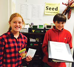 Annika and Jack, 7th graders at Hall Middle School in Larkspur, California, show off the school's seed lending library.