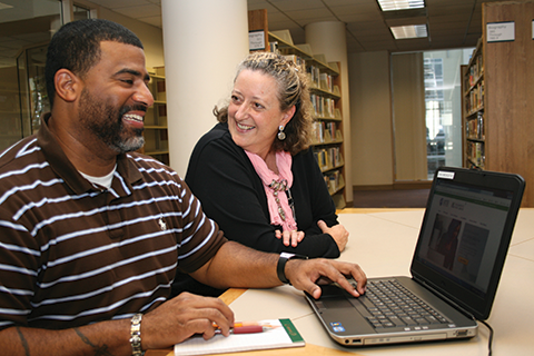 Mario Rideaux, COHS student at Sacramento Public Library, and Volunteer Services Coordinator Cathy Crosthwaite discuss next steps.