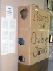 Brown paper with burned-in peep holes surrounds a bookcase at Robinson Memorial Library in Cleveland, Mississipi. The paper surrounds 22 banned or challenged books from the Radcliffe Publishing Course Top 100 Novels of the 20th Century.