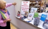 Jo Roussey, director of volunteer services at York County (Pa.) Libraries’ Martin branch, sets up a display of the top 10 books most frequently challenged or requested to be removed from libraries.