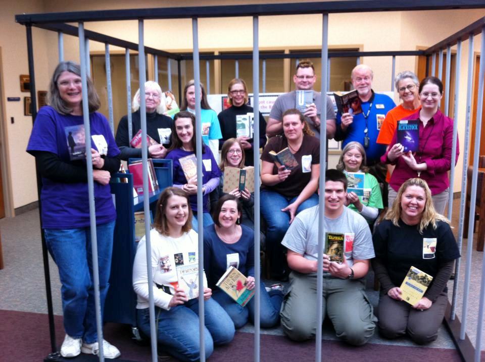Staff members at Brownsburg (Ind.) Public Library, some wearing special T-shirts, read banned books in a makeshift jail.