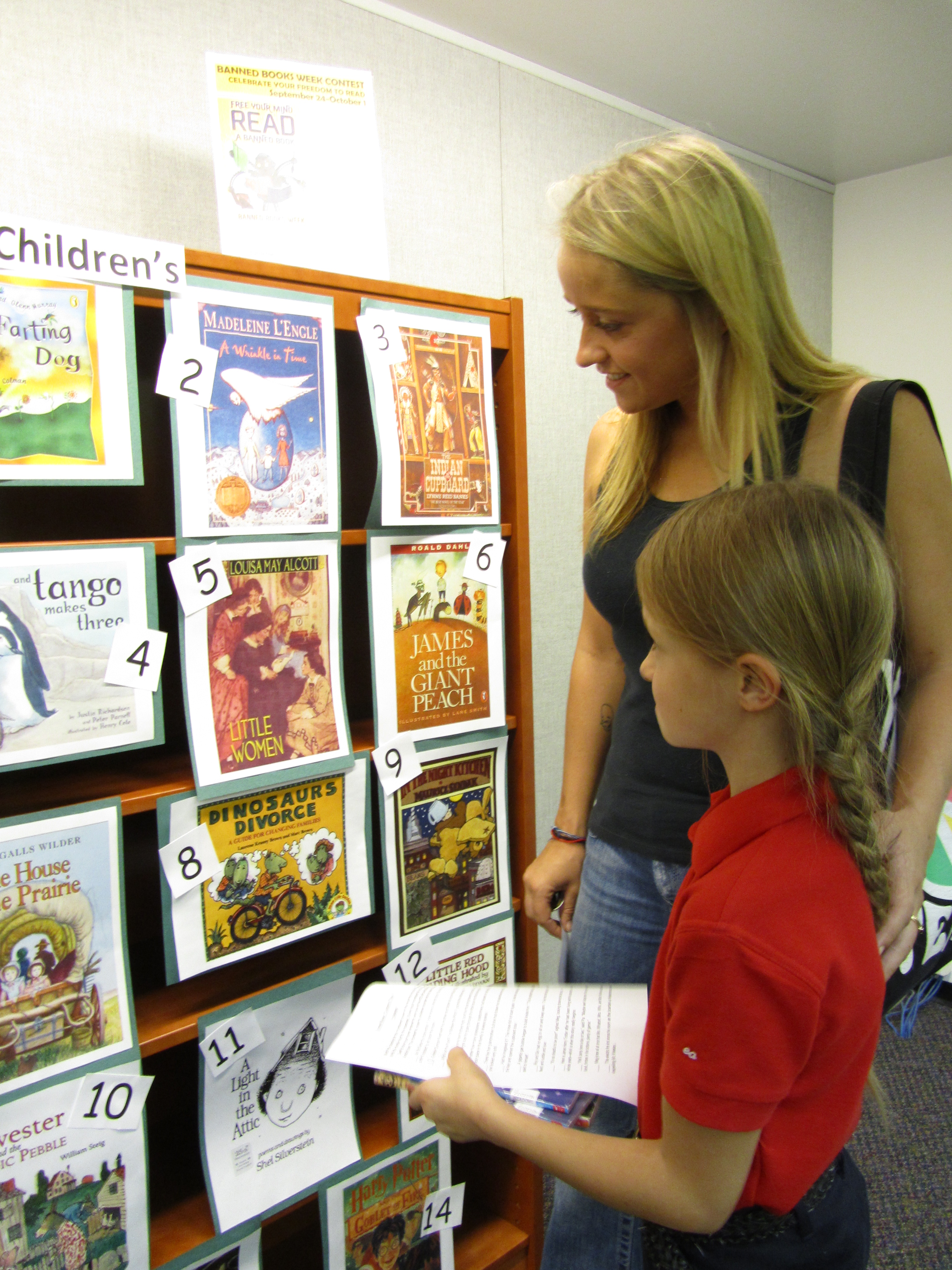 Patrons match passages from banned books with their respective covers at Bemis Public Library in Littleton, Colorado. More than 30 book covers were on display.