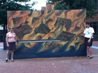 Jefferson-Madison Regional Library staff members Zanne Macdonald (left) and Krista Farrell pose next to a mural drawn by Sam Welty on the Free Speech Wall along Charlotteville,Virginia’s pedestrian mall. The library partnered with the Thomas Jefferson Center for Free Expression for a series of BBW events funded by an ALA Judith Krug Memorial Fund grant.