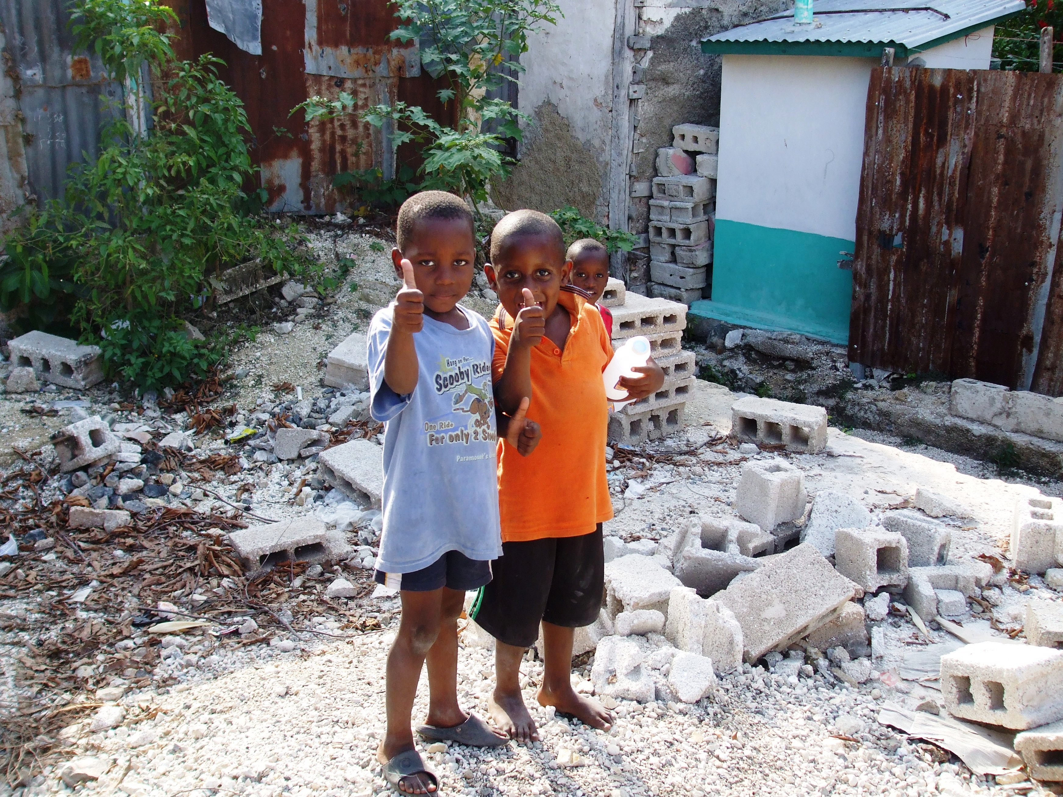 Haitian boys give thumbs up to a new school rising in Petit-Goâve.