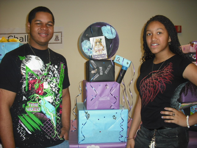 Ryan Beasley ( left) and Keisha White show off their winning Most Original cake during the Second Annual Boss of Cakes Competition April 10 at Newport News (Va.) Public Library System's Pearl Bailey branch. Youth ages 8-18 competed in the event by creating giant birthday cakes using boxes and other craft materials.