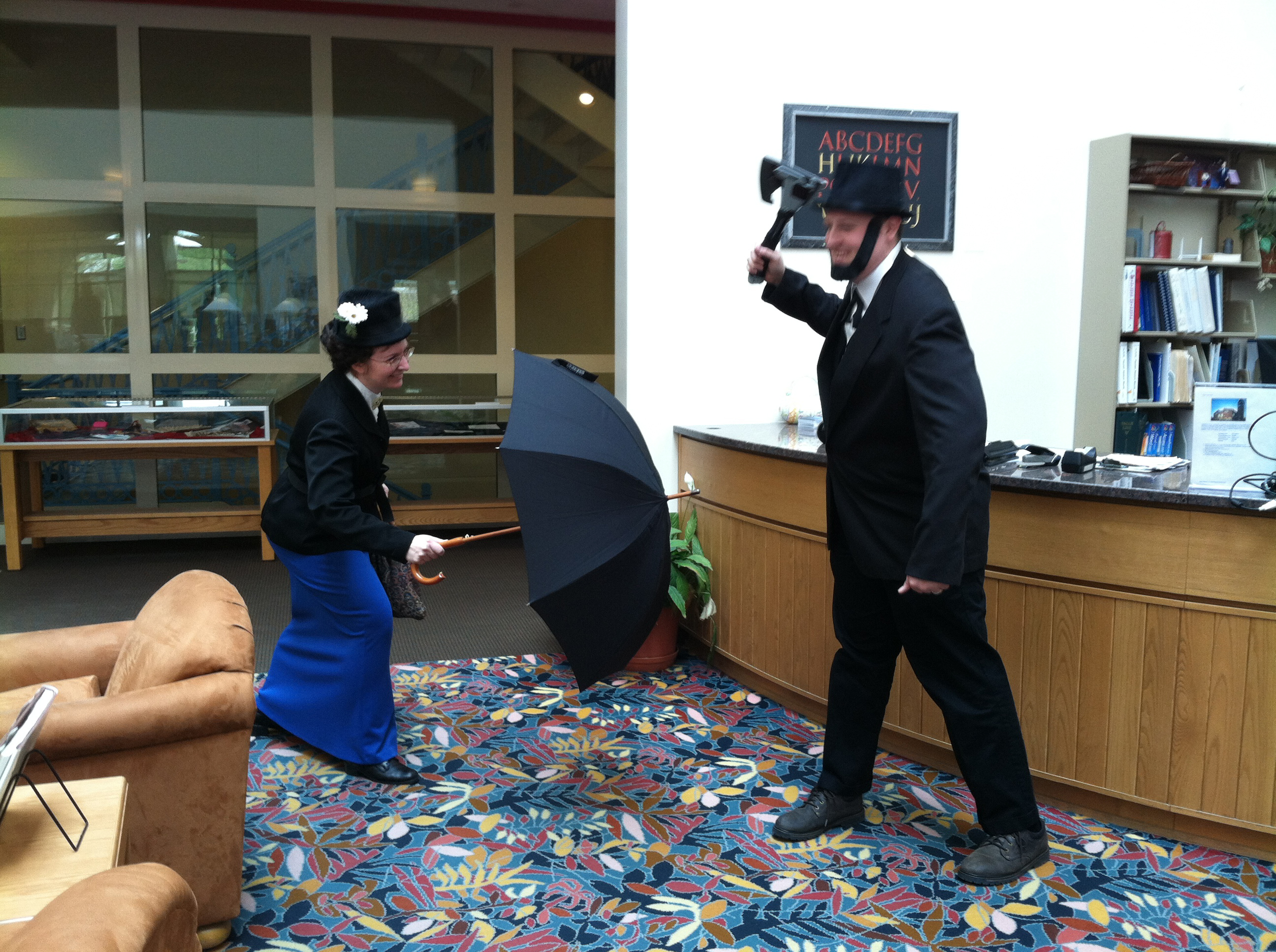 Mary Poppins and Abraham Lincoln, depicted by St. Ambrose University Library staffers, stage a mock battle during Dress Like a Literary Character Day at the Davenport, Iowa, university. Other events inlcuded the 11th annual Paper Plane Flying Contest and a life-sized Angry Birds game.