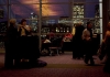 Attendees of YALSA's Happy Hour mingle in front of the Boston skyline. 