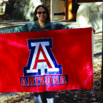 Virginia Sanchez, librarian at Yosemite National Park, poses with a flag from the University of Arizona, her alma mater.