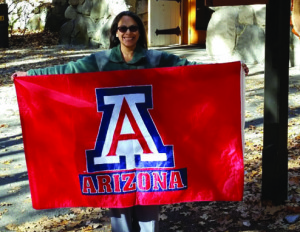 Virginia Sanchez, librarian at Yosemite National Park, poses with a flag from the University of Arizona, her alma mater.