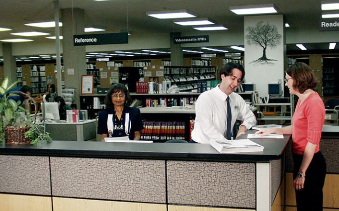 The author (wearing a tie) at the reference desk before her transition.