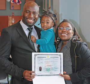 Oluwaleke Kehinde Ajayi receives his certificate of naturalization.