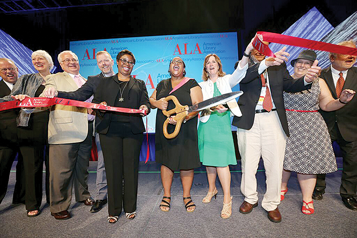 Past President Courtney L. Young cuts the ribbon after the Opening General Session on June 26.