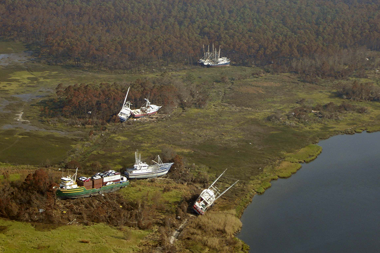 A cargo ship and fishing boats left grounded in Bayou La Batre, Alabama, after Hurricane Katrina came through in 2005. Photo: NOAA