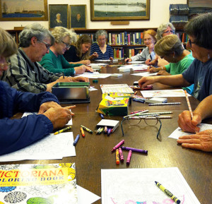 Members gather for the monthly coloring club at the library.