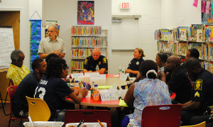 Richard Frieder (standing), community engagement director at Hartford Public Library, facilitates a community dialogue among neighborhood residents and Hartford police officers on the topic of community violence and public safety. The dialogue took place in June 2015 at Hartford Public Library's Barbour Street branch. (Photo: Judy Wyman Kelly)
