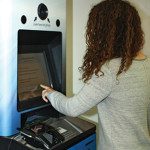 A patron renews her driver’s license inside Ames (Iowa) Public Library in June. Iowa DOT unveiled 11 kiosks in libraries in May.