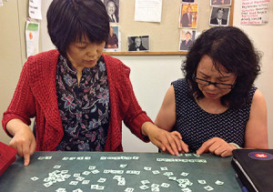 At the Littleton Immigrant Resources Center, students work with tiles to practice spelling for the writing portion of the citizenship exam. <span class="credit">Photo: Bemis Library</span>