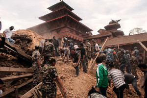 Workers remove rubble and earth from the foot of a temple destroyed in the April 25 earthquake in Nepal. Photo: Shutterstock.com