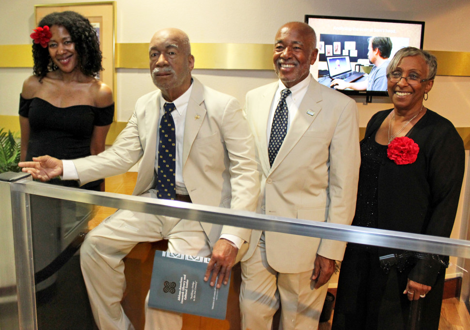 Former Broward County (Fla.) Library Director Samuel F. Morrison stands next to a replica of himself. It stands at the entrance of the African-American Research Library and Cultural Center in Fort Lauderdale.