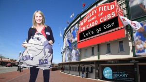 NPL Digital Services Supervisor Suzy Wulf poses with Summer Reading Club mascot Glummy in front of the Creative Studio’s green screen.