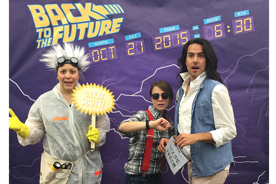 Salt Lake City Public Library System staffers pose as characters from the Back to the Future films. From left, teen services coordinator Christina Walsh as Doc Brown, children's services coordinator Liesl Johnson as Marty McFly, and adult services coordinator Tommy Hamby as Jennifer Parker. Photo: Salt Lake City Public Library System