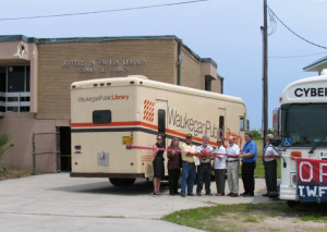 Jefferson Parish (La.) Library staff stands near a bookmobile from Waukegan (Ill.) Public Library and cybermobile from Muncie (Ind.) Public Library outside of the destroyed Grand Isle branch post-Katrina.Photo: Jefferson Parish Library