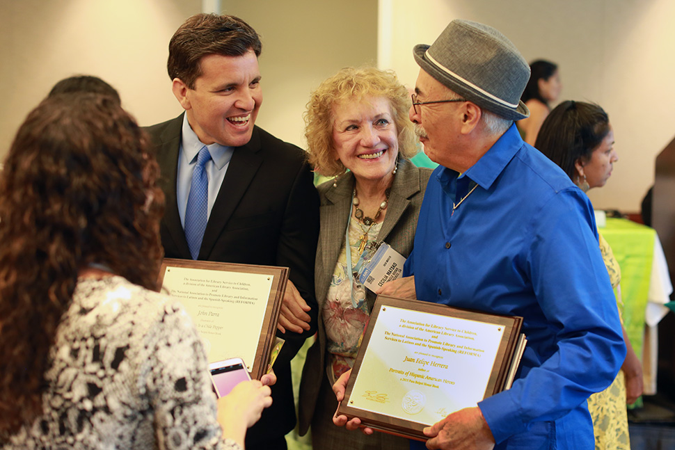 2015 Pura Belpré Illustration Honoree John Parra (left), conference attendee Cecilia Matsko, and 2015 Pura Belpré Author Honoree Juan Felipe Herrera gather during the 2015 ALA Annual Conference in San Francisco.