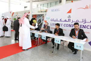 Participants arriving to register for the conference, helped by several hard-working interns.