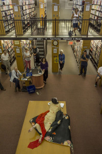 Otake performs on a table in the main reading room of Russell Library. Photo: William Johnston
