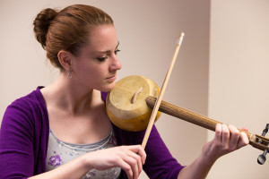 A music therapy student (a violinist) demonstrates how she experimented playing the Turkish spike fiddle before finding more official instructions.