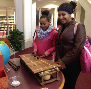 Students try out a West African balafon, a wooden xylophone-like instrument.