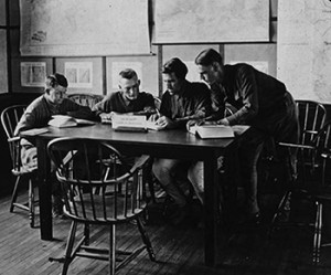 A group of four soldiers read in the ALA Camp Library at Camp Travis, Texas, 1918.