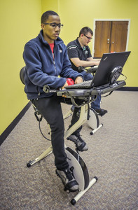 Troy University students ride the new exercise-study hybrid bikes at the Troy campus library. (Photo: Kevin Glackmeyer)