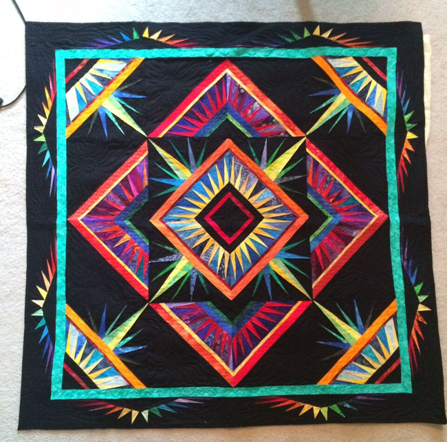 Based on the quilt design “Look Ma, No Curves” by famous quilter Deb Karasik, “Imagination Explosion” is a collaborative quilt led by Kelly Sattler.