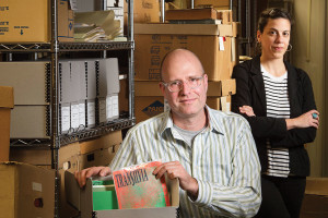Frank Bridges, media studies doctoral student, and Christie Lutz, New Jersey regional studies librarian and head of public services in Special Collections and University Archives, with items in the New Brunswick Music Scene Archive at Rutgers University.