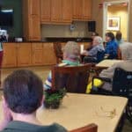 Marie Corbitt, outreach program librarian at Westerville (Ohio) Public Library, leads a “Remember When” storytime at a nursing facility. Photo: Westerville (Ohio) Public Library