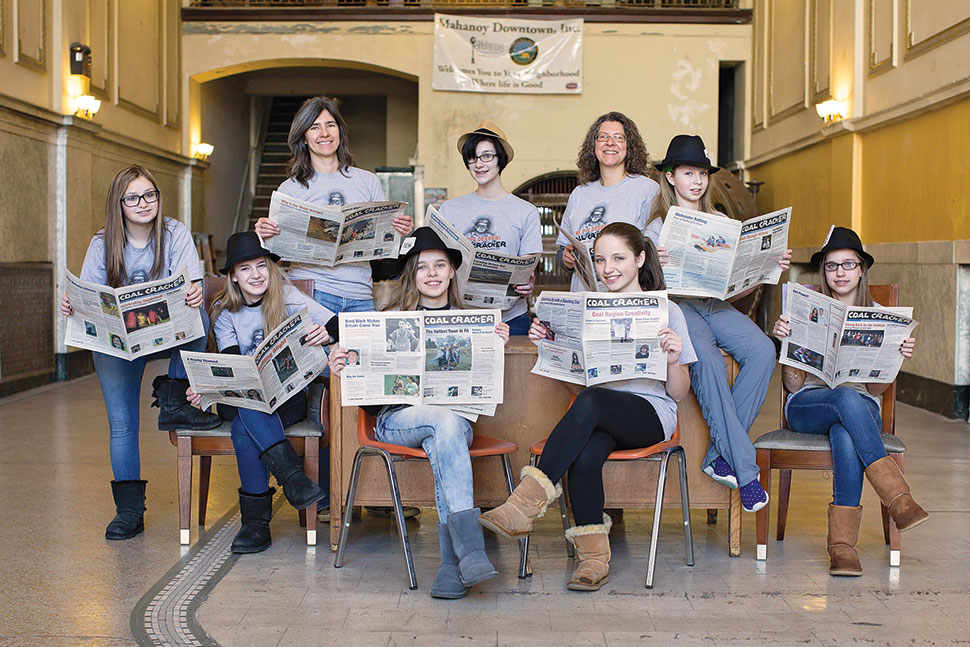 Mentors and student reporters for Coal Cracker in Mahanoy City, Pennsylvania, gather for a journalism training session inside the Teen Canteen, an old bank building that used to be a popular hangout in the 1950s and 1960s. Krista Gromalski (back, left) founded the community paper. Photo: Nikki Stetson