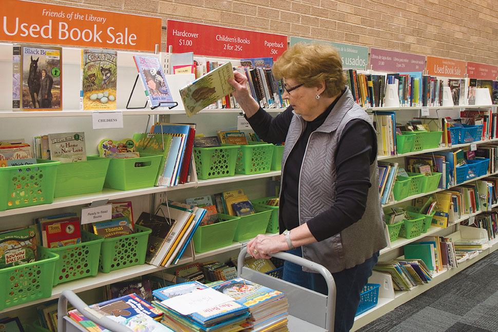 Kathy Clay, president of the ­Waukegan Public Library’s Friends of the Library, restocks children’s book for an upcoming book sale. Photo: Rebecca Lomax/American Libraries
