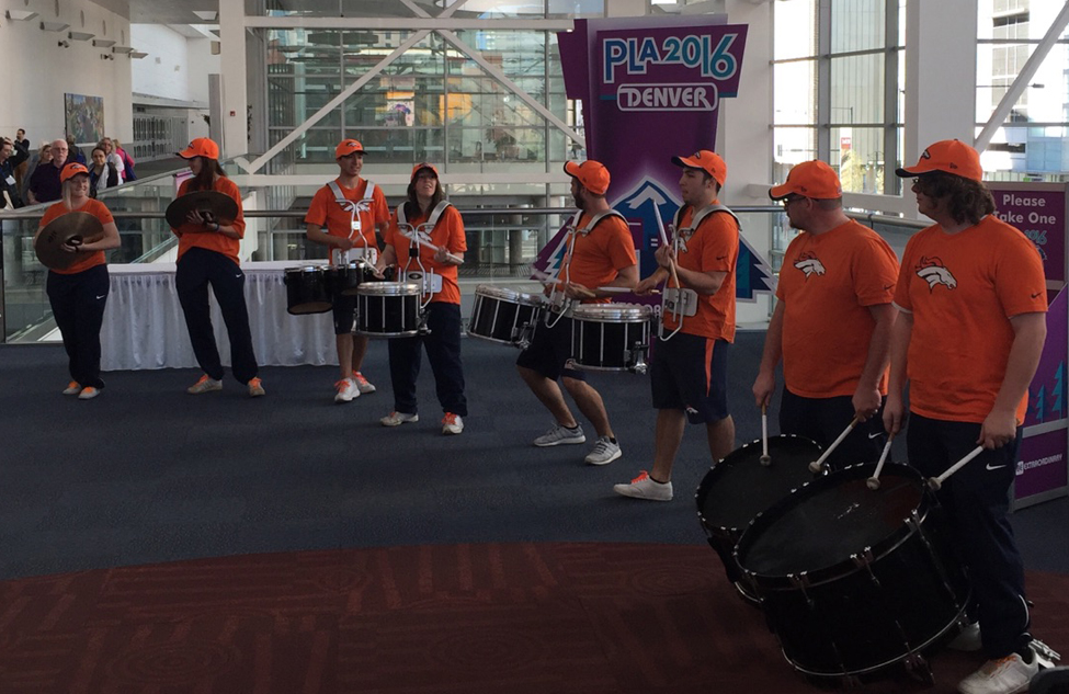 A drum line energizes the crowd and opens the exhibit hall at the Public Library Association Conference in Denver.