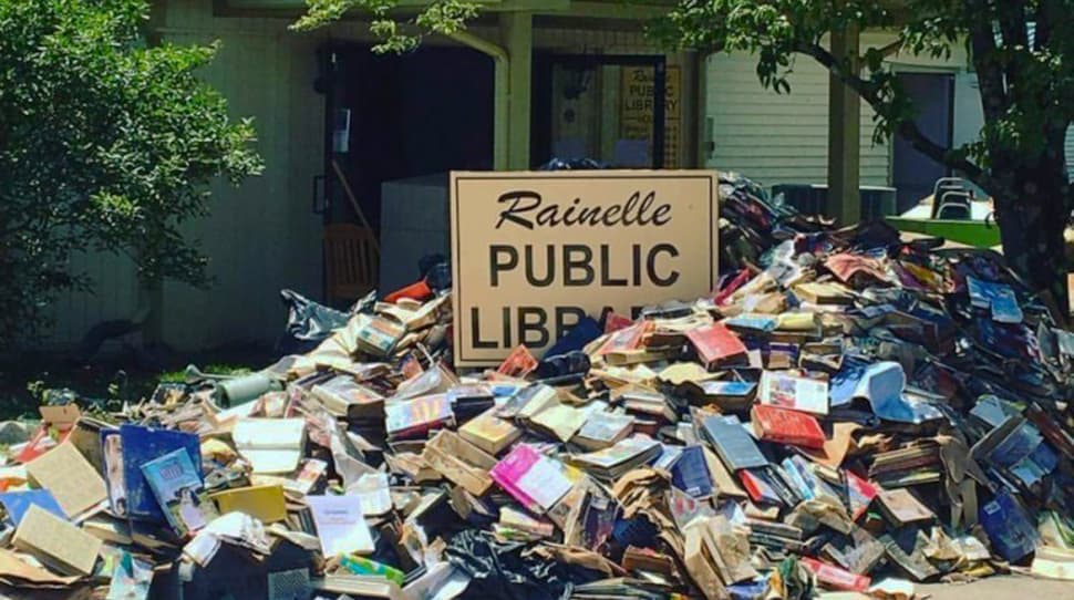 Water-soaked books await pickup outside the flooded Rainelle (W.Va.) Public Library.