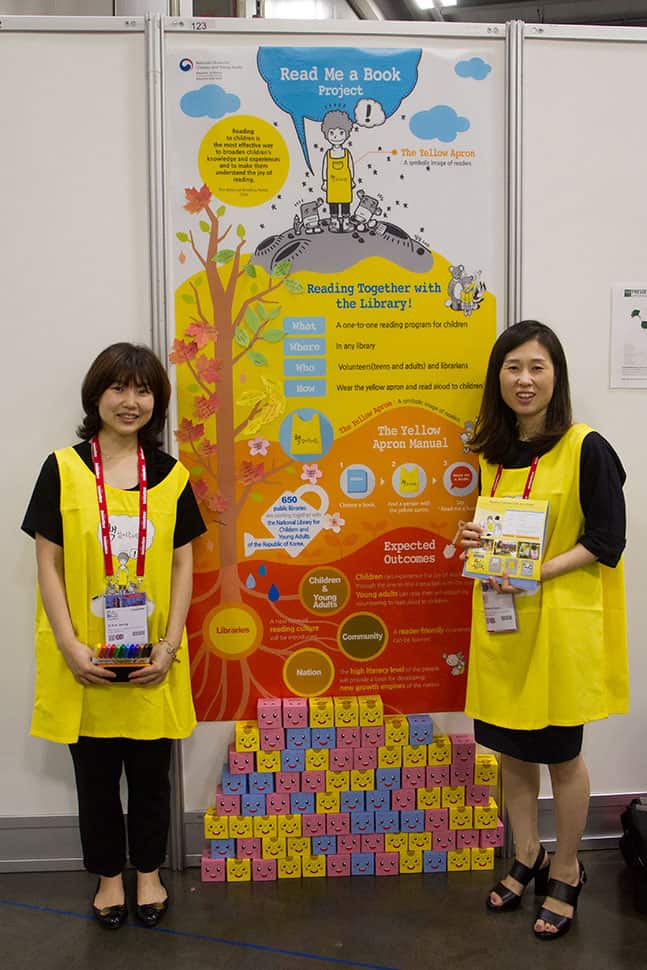 Ji Yun Jeong and Seo Hyon Kwon with the National Library for Children and Young Adults in the Republic of Korea donned their yellow vests to promote the library’s Read Me a Book program. Children at the library are encouraged to choose a book and take it to a volunteer in a yellow vest who will read it to them. “It’s a win-win situation. Teenagers get to read a book, and children get read to,” Jeong said.