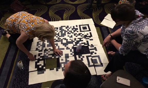 Attendees at the Gaming As Meaningful Education conference, cosponsored by the American Association of School Librarians and the American Library Association’s Games & Gaming Round Table, solve puzzles in an escape room challenge.